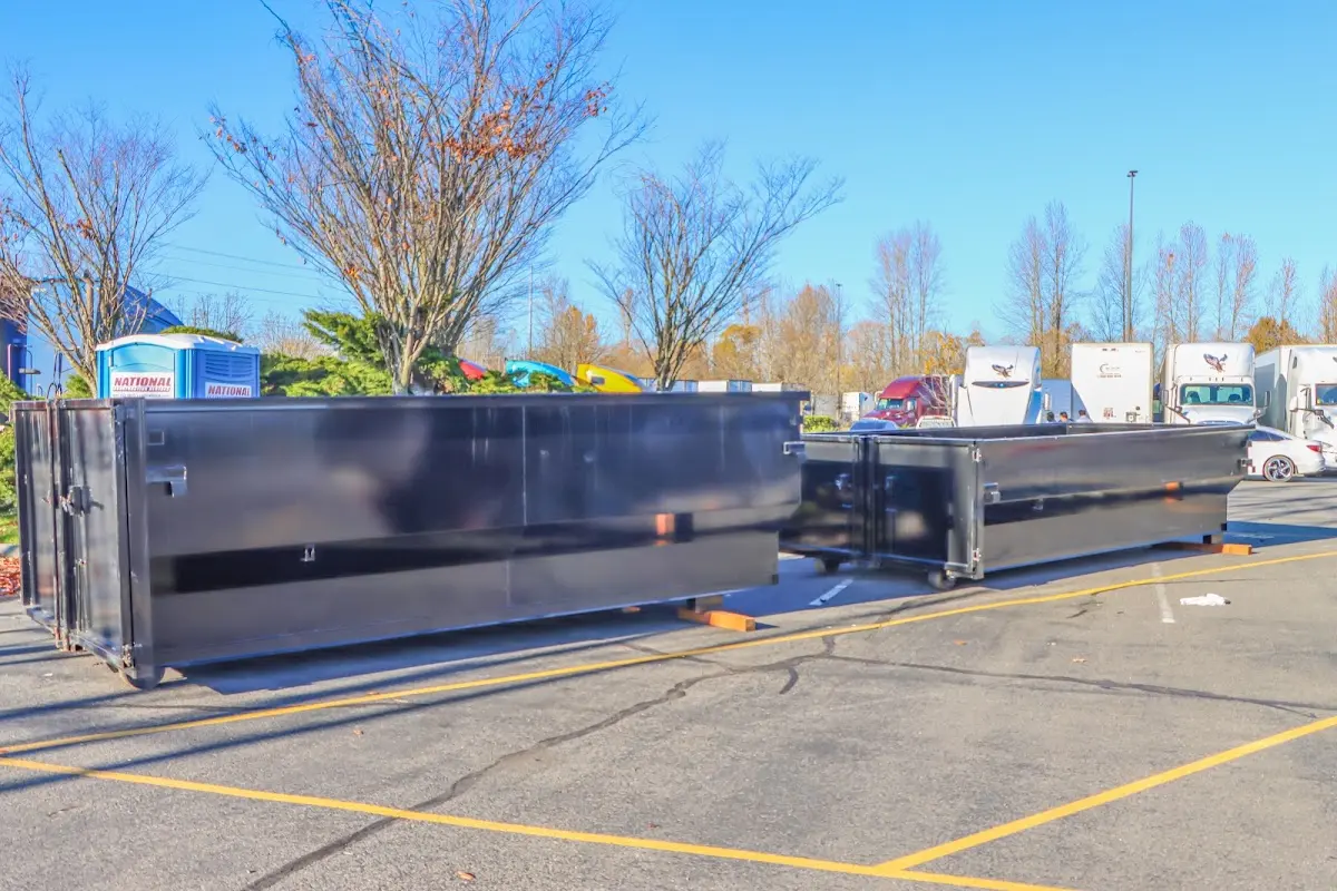 Professional dumpster rental service with roll-off container on residential driveway in Detroit Lakes